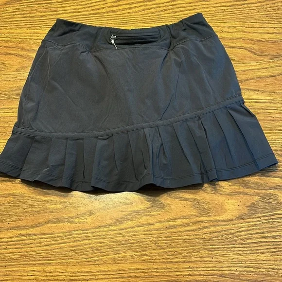 FlirTee Asymmetrical Pleated Golf Skirt - Picture 2 of 13